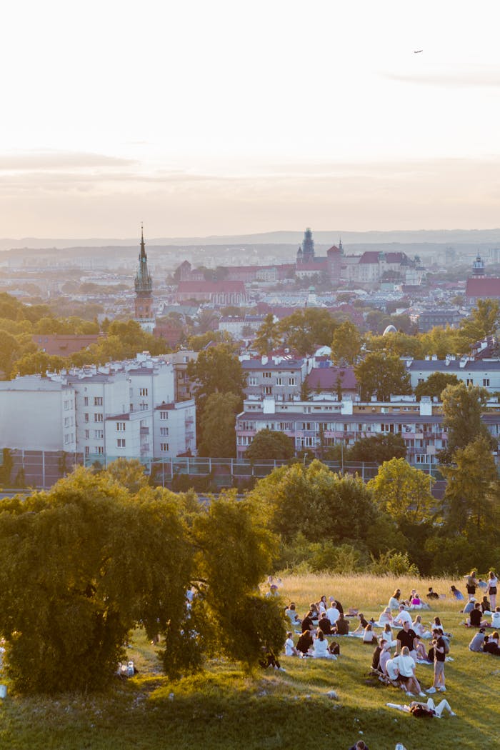 about-02 Enjoy a summer sunset view over Kraków with people relaxing in a park.